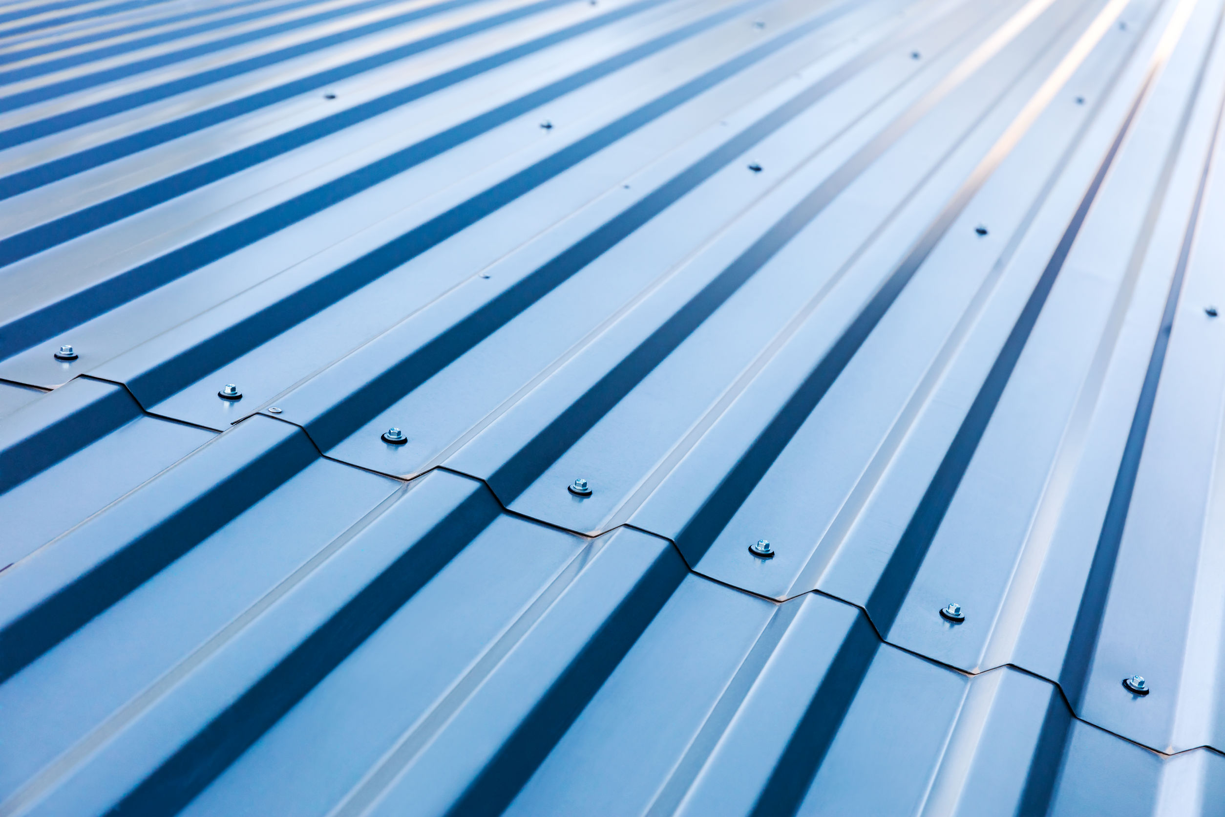 62787675 - blue corrugated metal roof with rivets, industrial background
