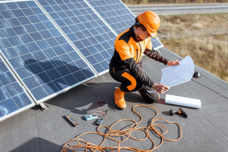 electrician installing solar panels LKUC8TR e1632147586304